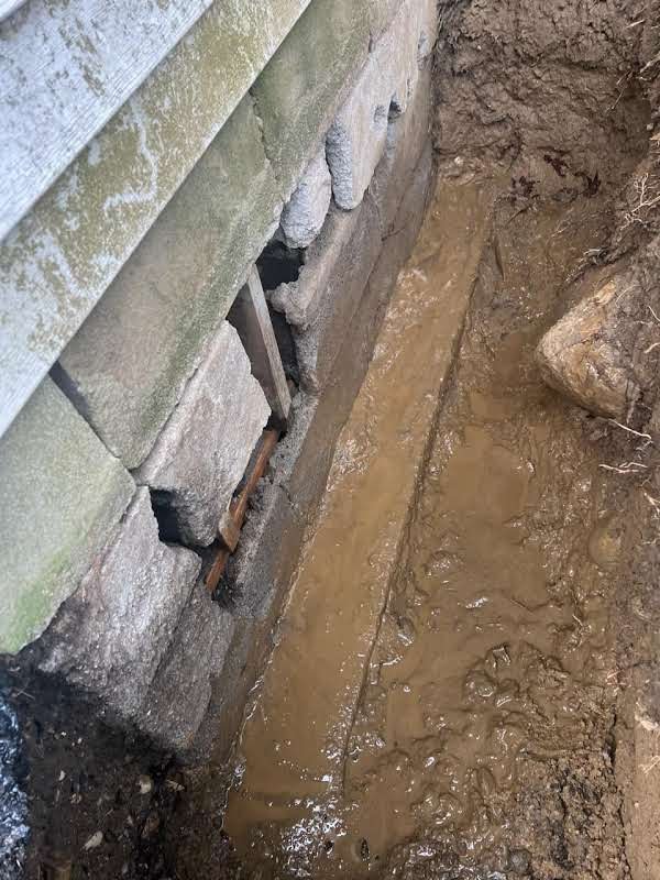 Before: leaking foundation crack repair with exterior excavation, masonry rebuild and waterproofing membrane in Carmel, NY