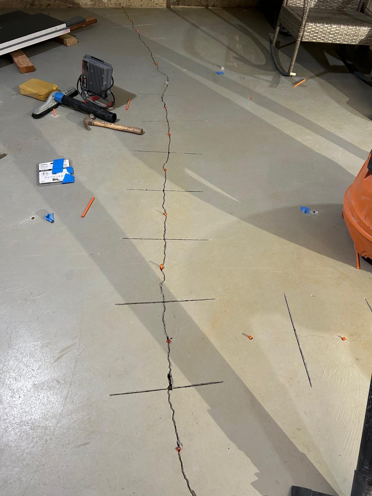 Before: garage slab structural crack stitched with carbon fiber and Kevlar stabilization bars in Weston, CT