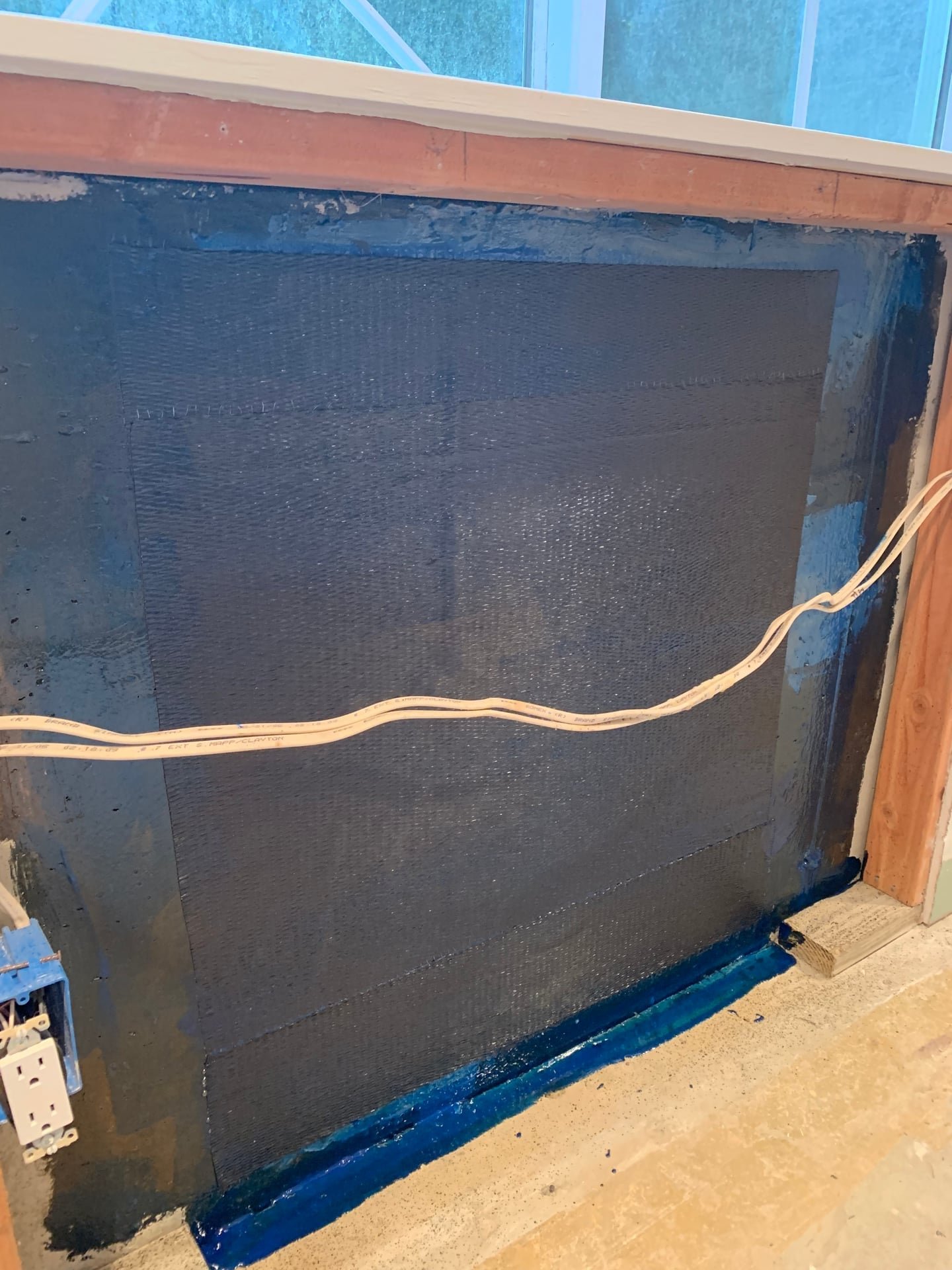 structural foundation crack repair with carbon fiber strap reinforcement near window opening in Armonk, NY — after