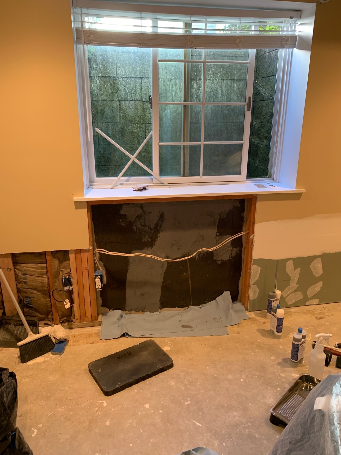 Before: structural foundation crack repair with carbon fiber strap reinforcement near window opening in Armonk, NY